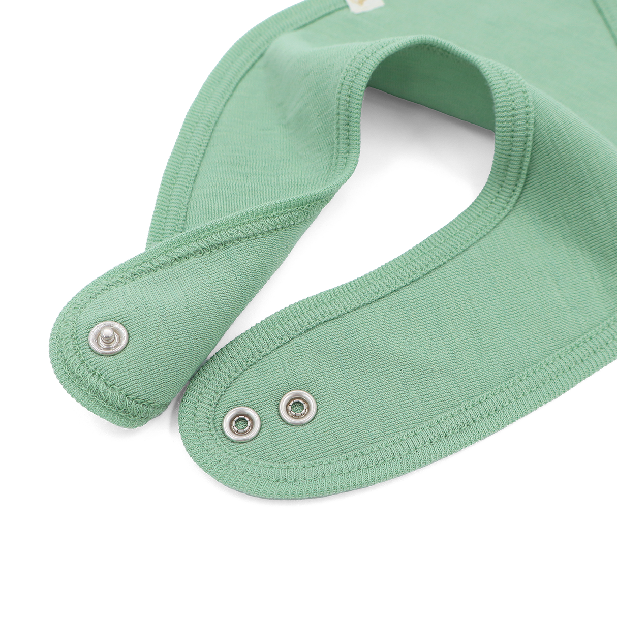 Bib from 100% certified fine merino with a pacifier clip function